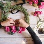 Florist at work: Creating a wooden wreath with flowers. christma